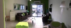 a living room with a couch and a table at Ayia Napa Cyprus in Paralimni