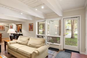a living room with a couch and sliding glass doors at Cottonwoods 1-D in Aspen +33 photos
