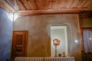 a room with a table with a lamp and a mirror at Radika View House in Galičnik