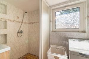 a bathroom with a shower and a sink and a window at Big House with Sauna, 25-metre from the lake in Borek +35 photos