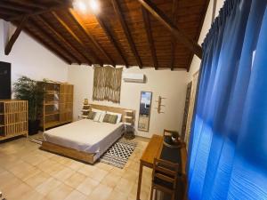 a bedroom with a bed and a wooden ceiling at Spitaki Guest House in Megali Ammos