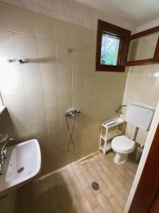 a bathroom with a shower and a toilet and a sink at Spitaki Guest House in Megali Ammos