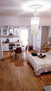 a room with a bed and a dining room and a kitchen at Ammos studio Loutraki in Loutraki