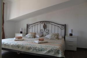 a bedroom with a large bed with two pillows on it at Nikola Leko Guest House in Hvar