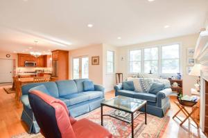 a living room with a blue couch and a table at Beautiful Family Home Walk to Beach in Eastham