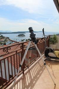 a camera on a tripod on a balcony at Nikola Leko Guest House in Hvar