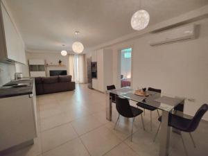 a kitchen and living room with a table and chairs at Perfect place in Il-Gżira