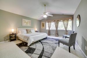 a bedroom with a bed and a chair and a window at Spacious Reno Home with Deck about 1 Mi to Downtown! in Reno
