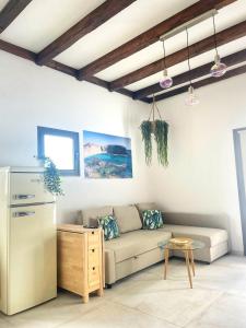 a living room with a couch and a refrigerator at Sunrise IN LOFT in Playa Honda