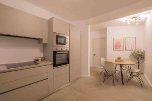 a kitchen and dining room with a table and chairs at Wanderlust 2 in Sliema