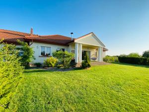 a house with a lawn in front of it at Siedlisko Wytowno in Ustka