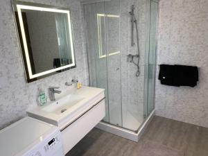 a bathroom with a shower and a sink and a mirror at Fly Away Home condo with terrace in Qormi +12 photos