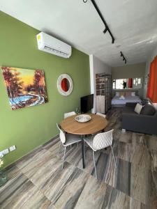 a living room with a table and a couch at Fly Away Home condo with terrace in Qormi