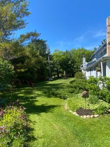a yard of a house with a green lawn at Sylvan Inn Bed & Breakfast in Glen Arbor