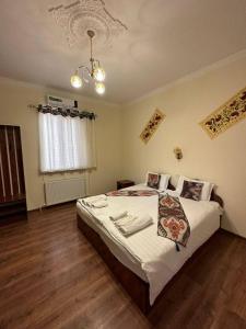 - une chambre avec un grand lit dans l'établissement ESHONI PIR Boutique HOTEL, à Boukhara
