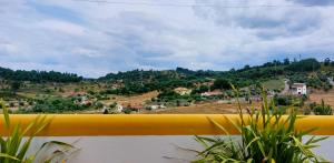 a view of a mountain from a balcony with plants at Quinta do Feonix in Martinchel