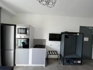 a kitchen with a stainless steel refrigerator and a chair at The Valley Room 6 with parking on premises in St Julian's