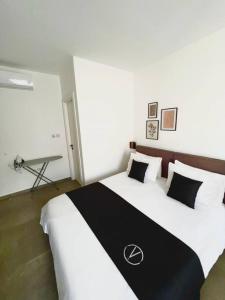a bedroom with a large bed with a black and white blanket at The Valley Room 6 with parking on premises in St Julian's