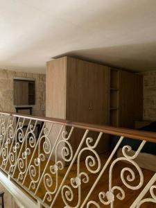 a staircase with a metal railing in a room at Serenity 2 in Qormi