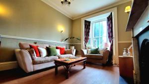 a living room with a couch and a coffee table at Holmwood House Guest Accommodation in York