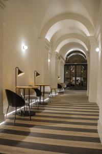 a hallway with tables and chairs in a building at Select Via Veneto in Rome