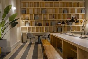 an office with a desk with two chairs and a bench at Select Via Veneto in Rome