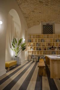 a room with a desk and chairs and a table at Select Via Veneto in Rome +29 photos