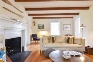 a living room with a couch and a fireplace at Beautifully Renovated in Harwich Center in Harwich