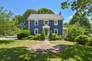 a blue house with bushes in a yard at Beautifully Renovated in Harwich Center in Harwich