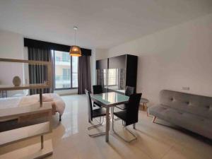 a bedroom with a bed and a table and chairs at Seaview apartment Sliema in Sliema