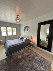 a bedroom with a bed and a large mirror at Iiris in Imatra