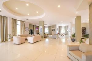 A seating area at Gouves Bay by Omilos Hotels