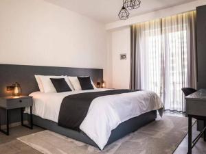 a bedroom with a large bed with a large window at The Valley Room 8 condo with parking on premises in St Julian's