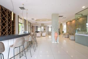 A seating area at Gouves Bay by Omilos Hotels