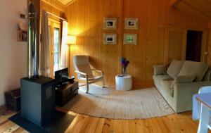 a living room with a couch and a stove at Tree Pool Villa in Arcos de Valdevez