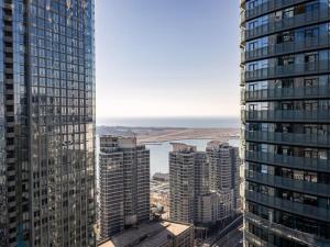 an aerial view of a city with tall buildings at Pristine Modern 2BR Condo Private BBQ and Balcony in Toronto