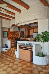 a kitchen with a tree in the middle of it at Balcones Del Mar in Rosarito