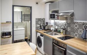 a kitchen with a sink and a washing machine at 1 Bedroom Stunning Apartment In Bayonne in Bayonne
