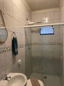 a bathroom with a shower and a toilet and a sink at Pousada Bravo in Balneário Camboriú +118 photos