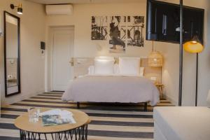 a bedroom with a bed and a table at Select Via Veneto in Rome