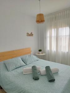 a bedroom with a bed with two pillows on it at Un lugar llamado descanso in Matalascañas