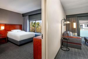 a hotel room with a bed and a desk at Courtyard by Marriott Boston Andover in Andover