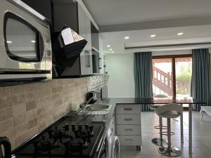 a kitchen with a stove and a counter top at Cactus Garden Kalkan - Private Mediterranean Home at Club Patara in Kalkan