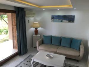a living room with a couch and a table at Cactus Garden Kalkan - Private Mediterranean Home at Club Patara in Kalkan