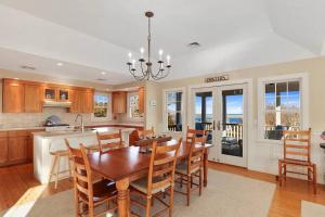 a kitchen and dining room with a table and chairs at Stunning Home w Incredible Water Views in Chatham