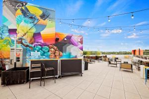 a patio with a mural on the side of a building at Harthall Hotel in Nashville
