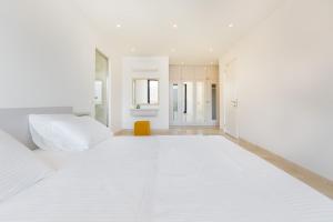 a white room with a large white bed in it at villa ozma in Kaş +17 photos