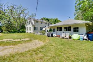 a house with a yard with chairs in front of it at Mattapoisett Home on 7 Acres with Private Beach! in Mattapoisett