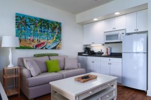 a living room with a couch and a kitchen at Harbour House at the Inn 316 in Fort Myers Beach