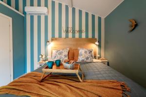 a bedroom with a bed with a table on it at La Mansarda Chic by TuscanyWeGo in Prato